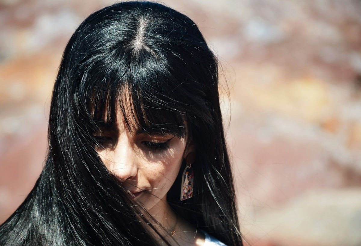 a close up of a woman with long black hair