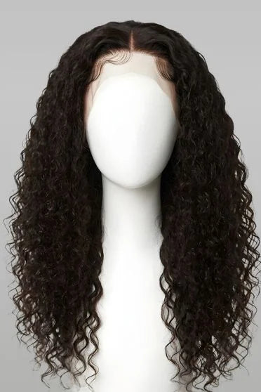 Black curly wig on a mannequin head against a gray background