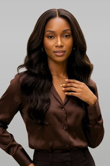 Woman wearing a brown blouse against a gray background