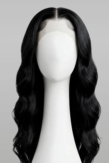 Black wig on a mannequin head against a gray background