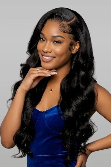 Woman with long, wavy black hair wearing a blue top against a gray background