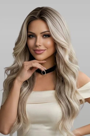 Woman with long, wavy hair wearing a black choker against a gray background