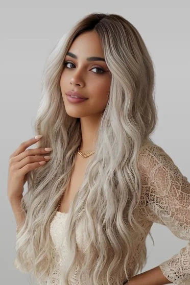 Woman with long, wavy hair posing against a plain background